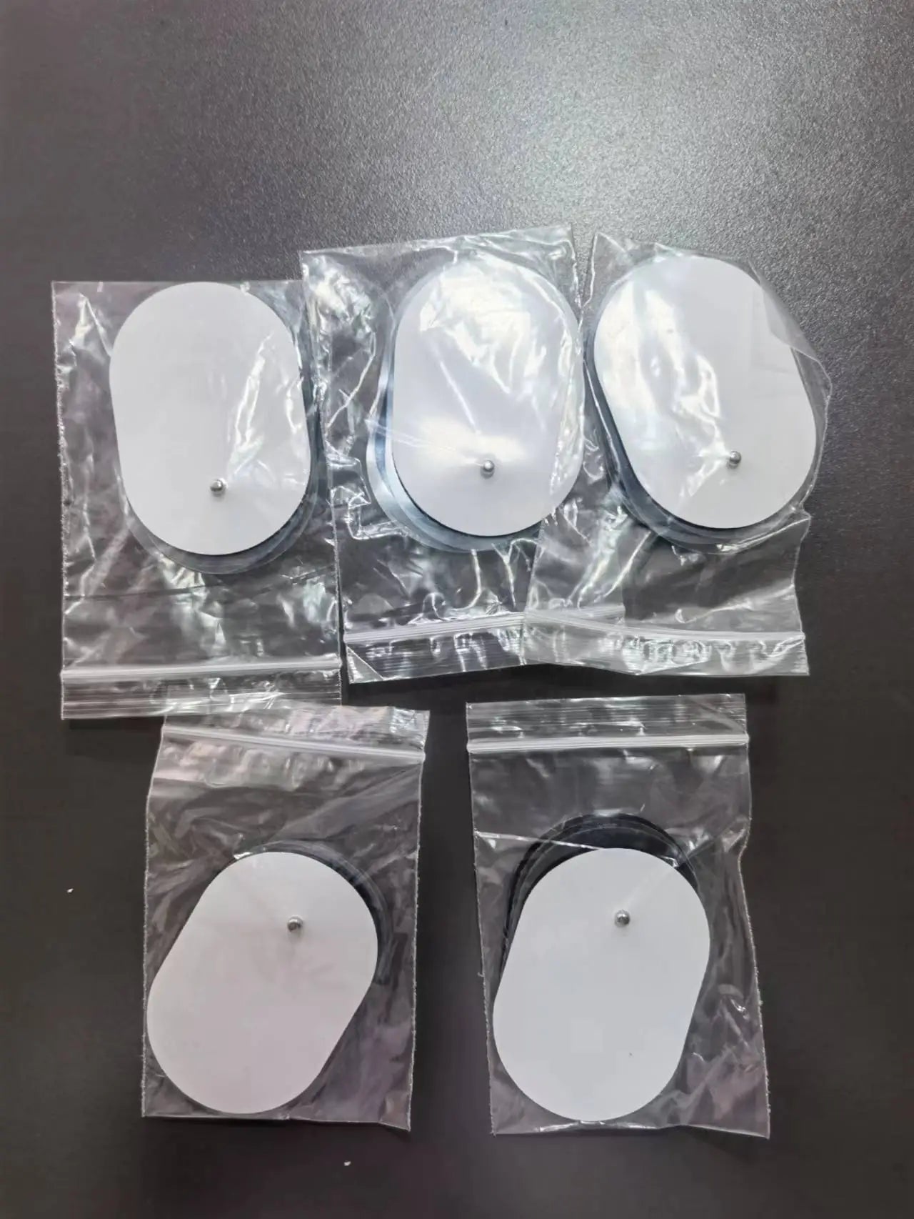 Mini Parche de Masaje EMS – Dispositivo Portátil de Terapia Electrónica